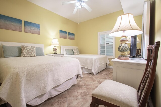 bedroom with ceiling fan and light tile patterned flooring