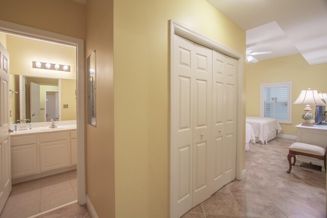 hallway with sink and light tile patterned floors