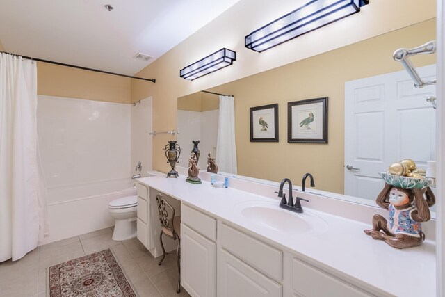 full bathroom with shower / tub combo with curtain, toilet, vanity, and tile patterned floors