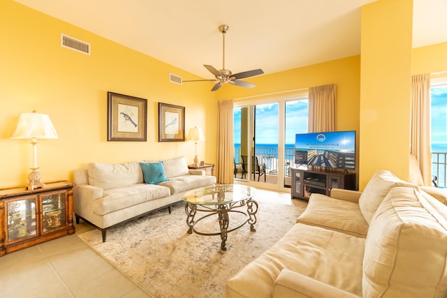 tiled living room with ceiling fan