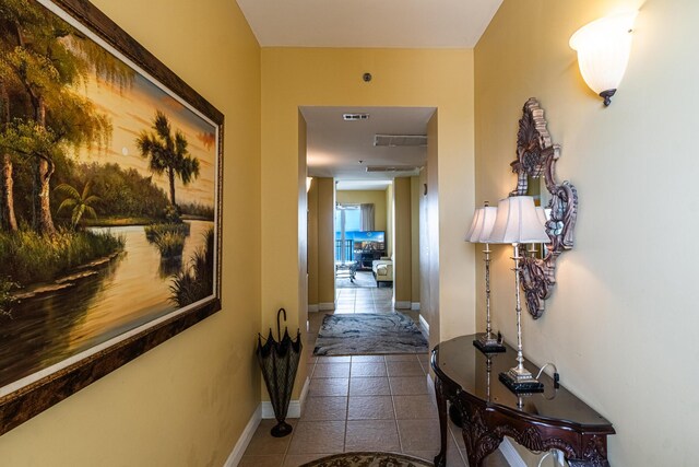 hall with tile patterned floors