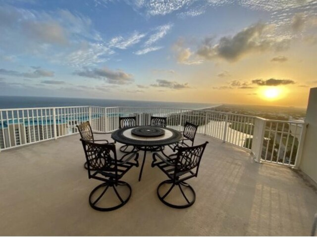 patio terrace at dusk with a water view