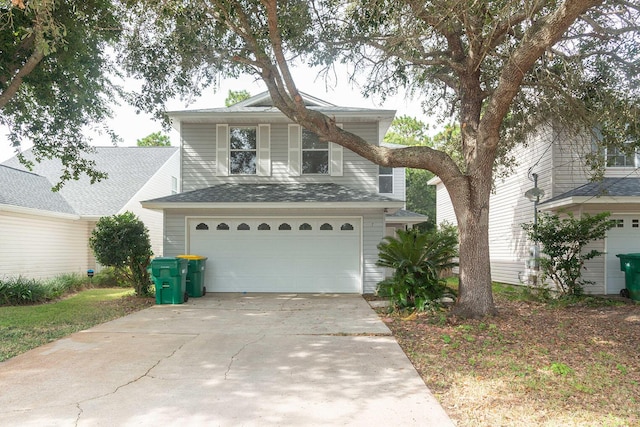 traditional-style home with concrete driveway and an attached garage