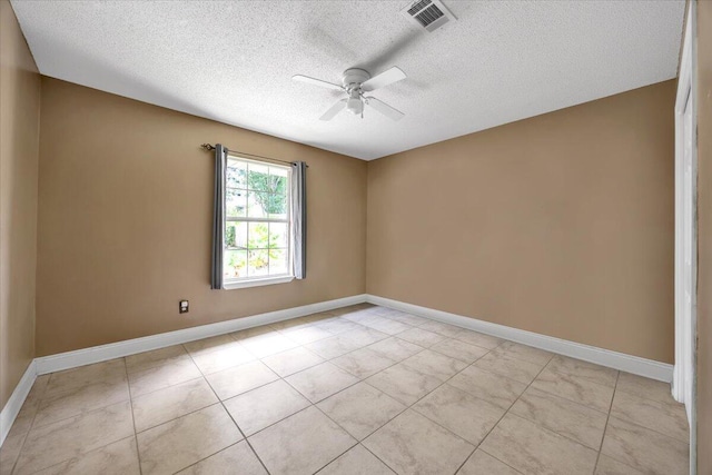 tiled empty room featuring ceiling fan and a textured ceiling