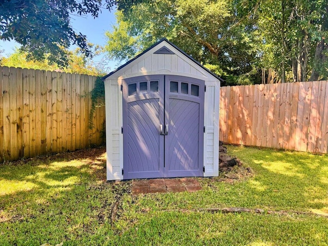 view of outdoor structure featuring a lawn