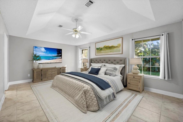 bedroom featuring light tile patterned floors, a textured ceiling, multiple windows, and ceiling fan