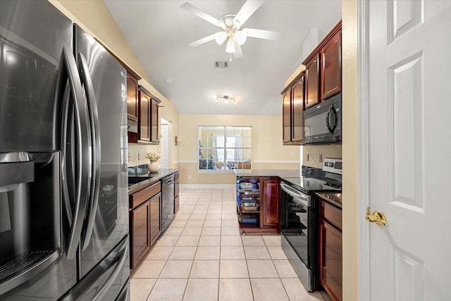 kitchen with appliances with stainless steel finishes, ceiling fan, lofted ceiling, and light tile patterned flooring