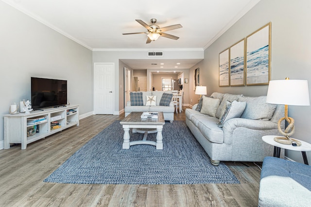 living room with ceiling fan, wood-type flooring, and crown molding