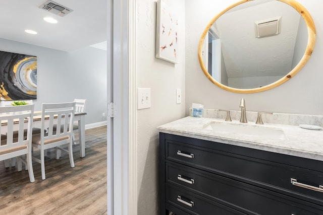 bathroom with hardwood / wood-style floors and vanity