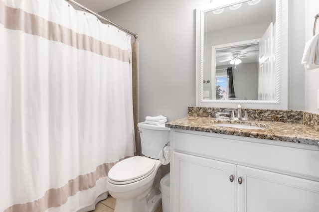 bathroom with vanity, tile patterned flooring, ceiling fan, toilet, and walk in shower