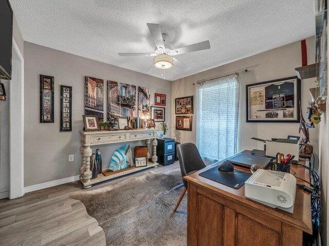 office with ceiling fan, a textured ceiling, and hardwood / wood-style floors