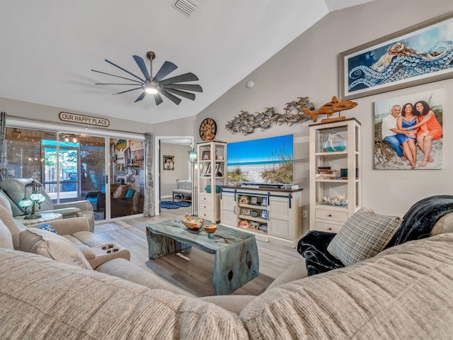 living room featuring ceiling fan, light hardwood / wood-style flooring, and lofted ceiling