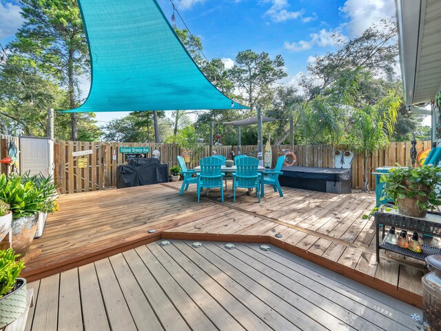 wooden deck featuring a hot tub