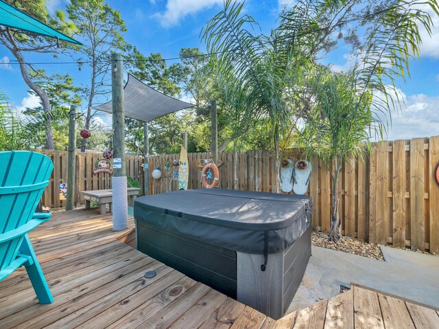 wooden terrace featuring a hot tub