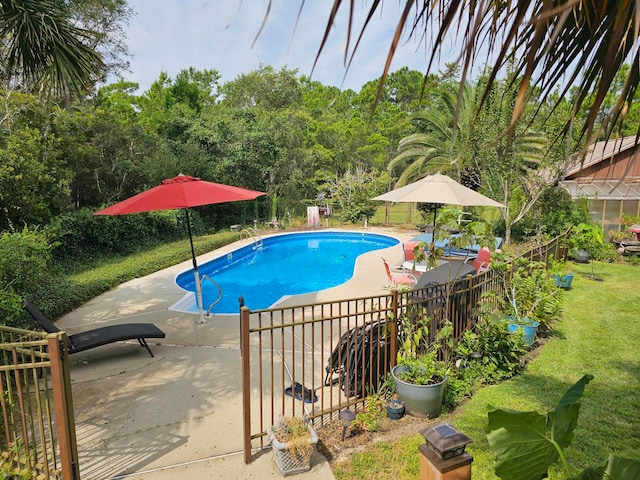 view of swimming pool with a yard and a patio area