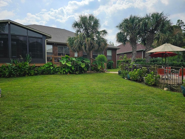 view of yard with a sunroom