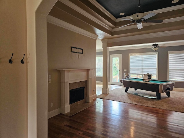 game room featuring ceiling fan, ornamental molding, a tile fireplace, billiards, and hardwood / wood-style floors