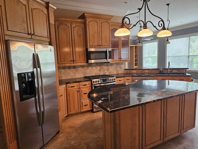 kitchen with hanging light fixtures, backsplash, stainless steel appliances, an inviting chandelier, and sink