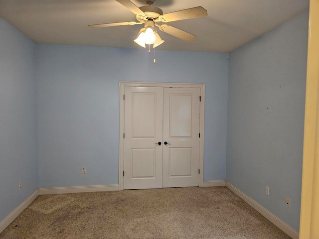 spare room with ceiling fan and light colored carpet