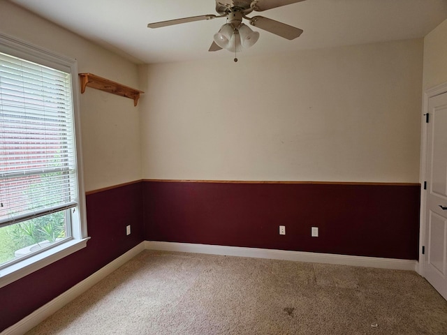 carpeted empty room featuring ceiling fan