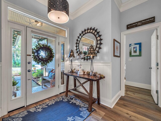 foyer entrance featuring hardwood / wood-style floors and ornamental molding