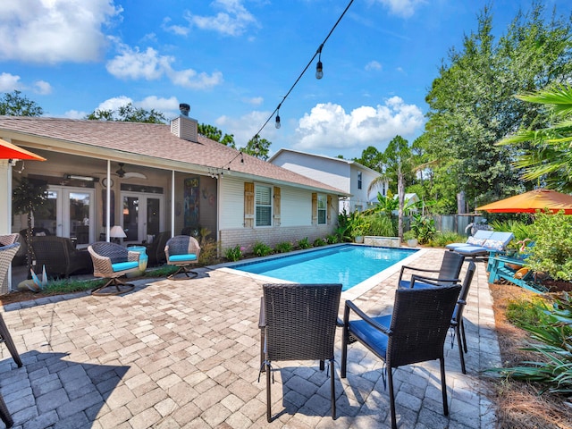 view of pool featuring a fenced in pool, a patio, ceiling fan, fence, and french doors