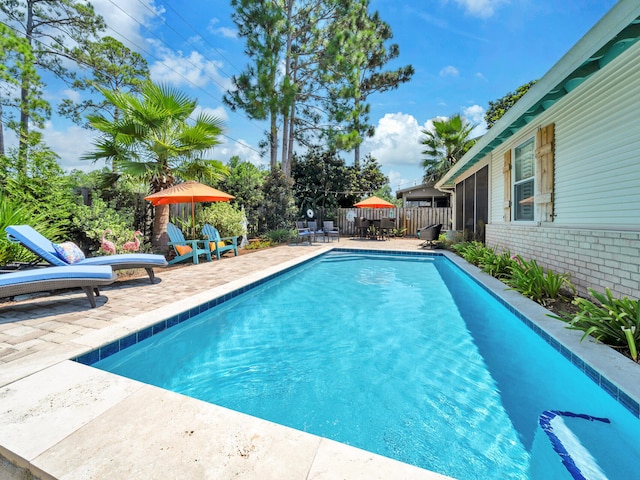 view of pool with a patio, fence, and a fenced in pool