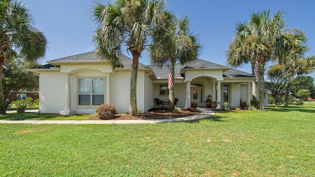 mediterranean / spanish-style house with a front lawn