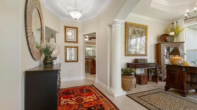 interior space with ceiling fan, a raised ceiling, crown molding, and ornate columns