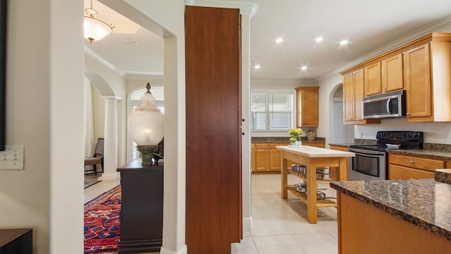 kitchen with crown molding, ornate columns, range with electric stovetop, light tile patterned flooring, and dark stone countertops