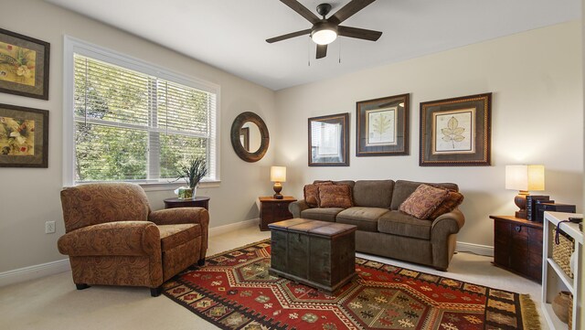 living room with ceiling fan and light carpet