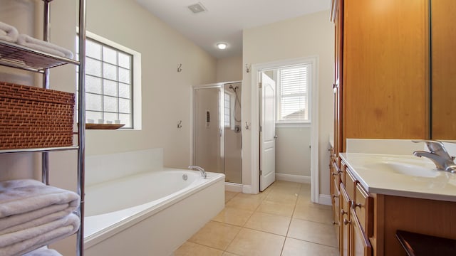 bathroom with tile patterned flooring, separate shower and tub, plenty of natural light, and vanity