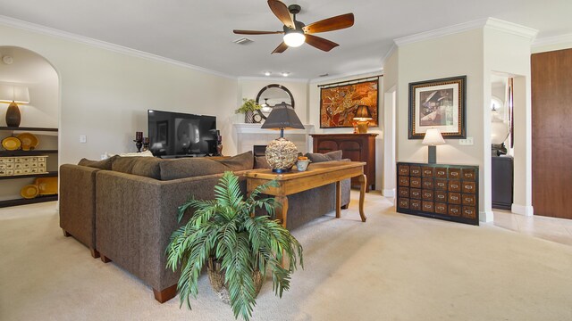 living room with ceiling fan, ornamental molding, and light carpet