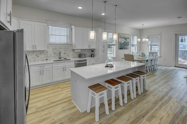 kitchen with sink, stainless steel appliances, and a healthy amount of sunlight