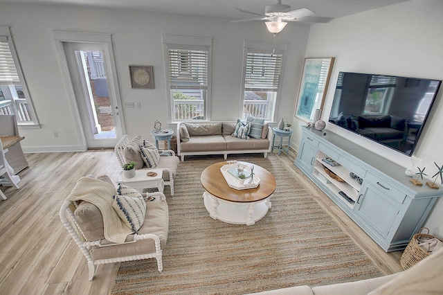 living room featuring light hardwood / wood-style flooring and ceiling fan