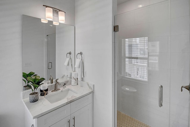 bathroom with vanity and a shower with shower door