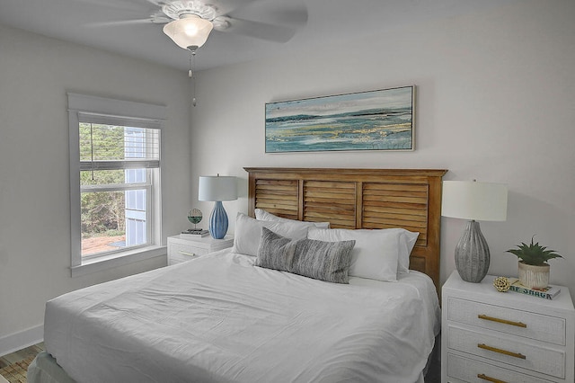 bedroom with ceiling fan and multiple windows