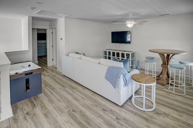 living room featuring light hardwood / wood-style floors and ceiling fan