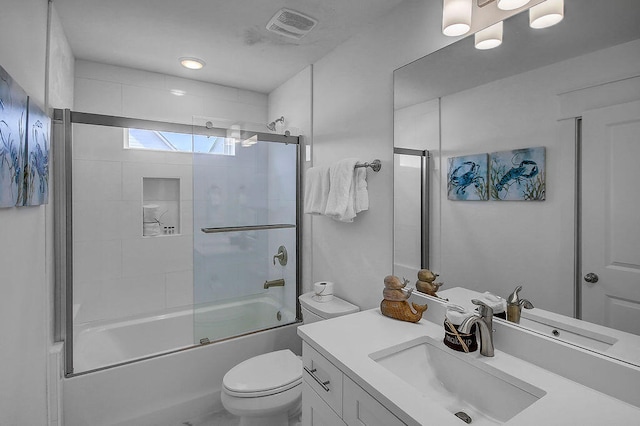 full bathroom with toilet, vanity, and enclosed tub / shower combo