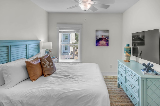 bedroom with ceiling fan and wood-type flooring