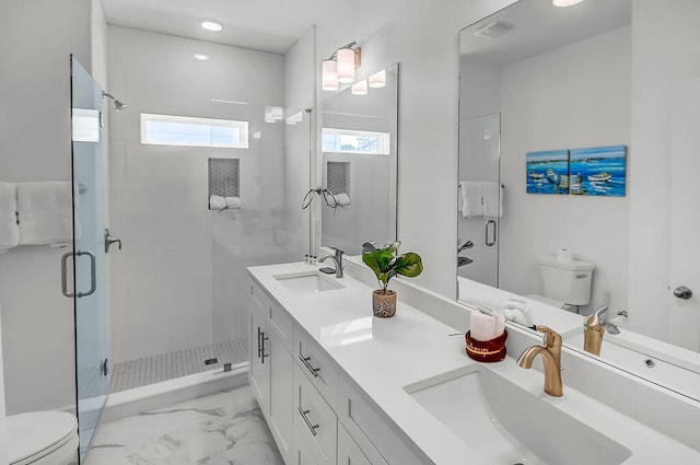 bathroom featuring a shower with shower door, toilet, dual bowl vanity, and tile patterned floors