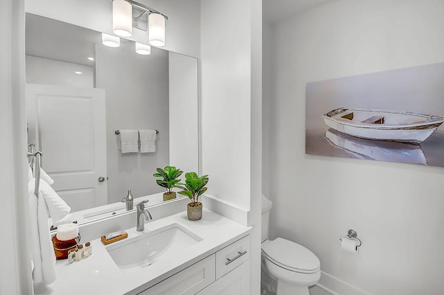 bathroom with toilet and vanity