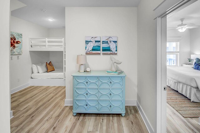 bedroom with light hardwood / wood-style flooring and ceiling fan