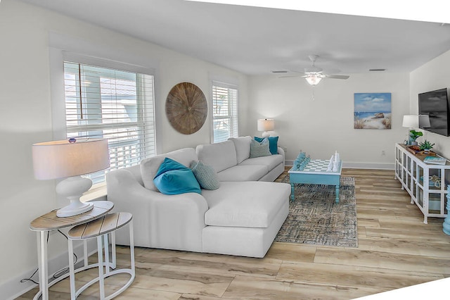 living room featuring light hardwood / wood-style flooring and ceiling fan