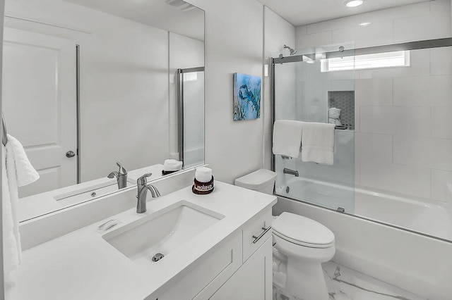 full bathroom with combined bath / shower with glass door, vanity, and toilet