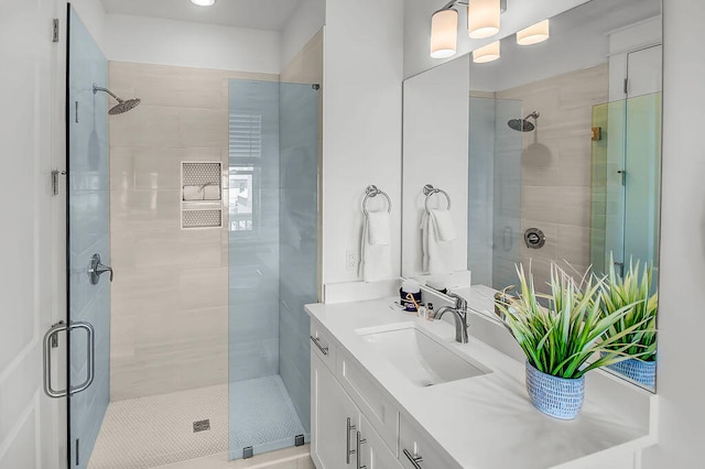 bathroom with a shower with door and vanity