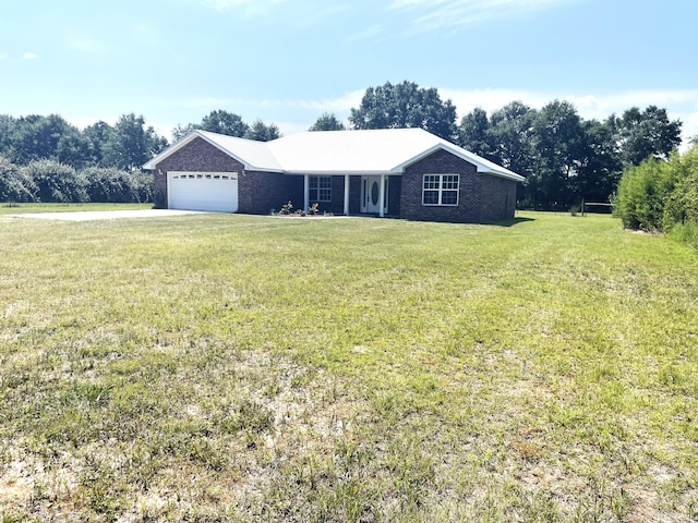 ranch-style house featuring a front yard and a garage