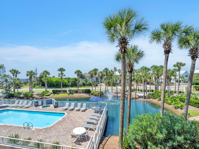 view of pool with a water view