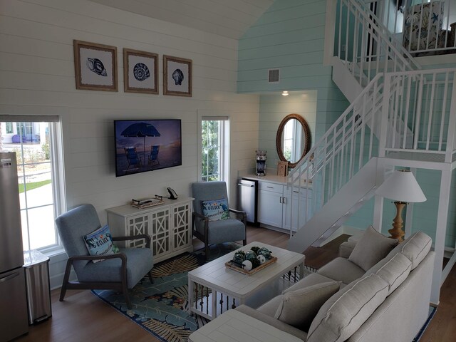 living room featuring a wealth of natural light, hardwood / wood-style flooring, and high vaulted ceiling