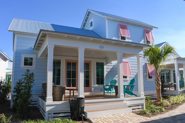 rear view of property featuring covered porch